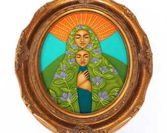 May include: A painting of two women with their faces close together, surrounded by green leaves and flowers. The women are wearing a green and blue robe with a floral pattern. The painting is framed in a gold oval frame.