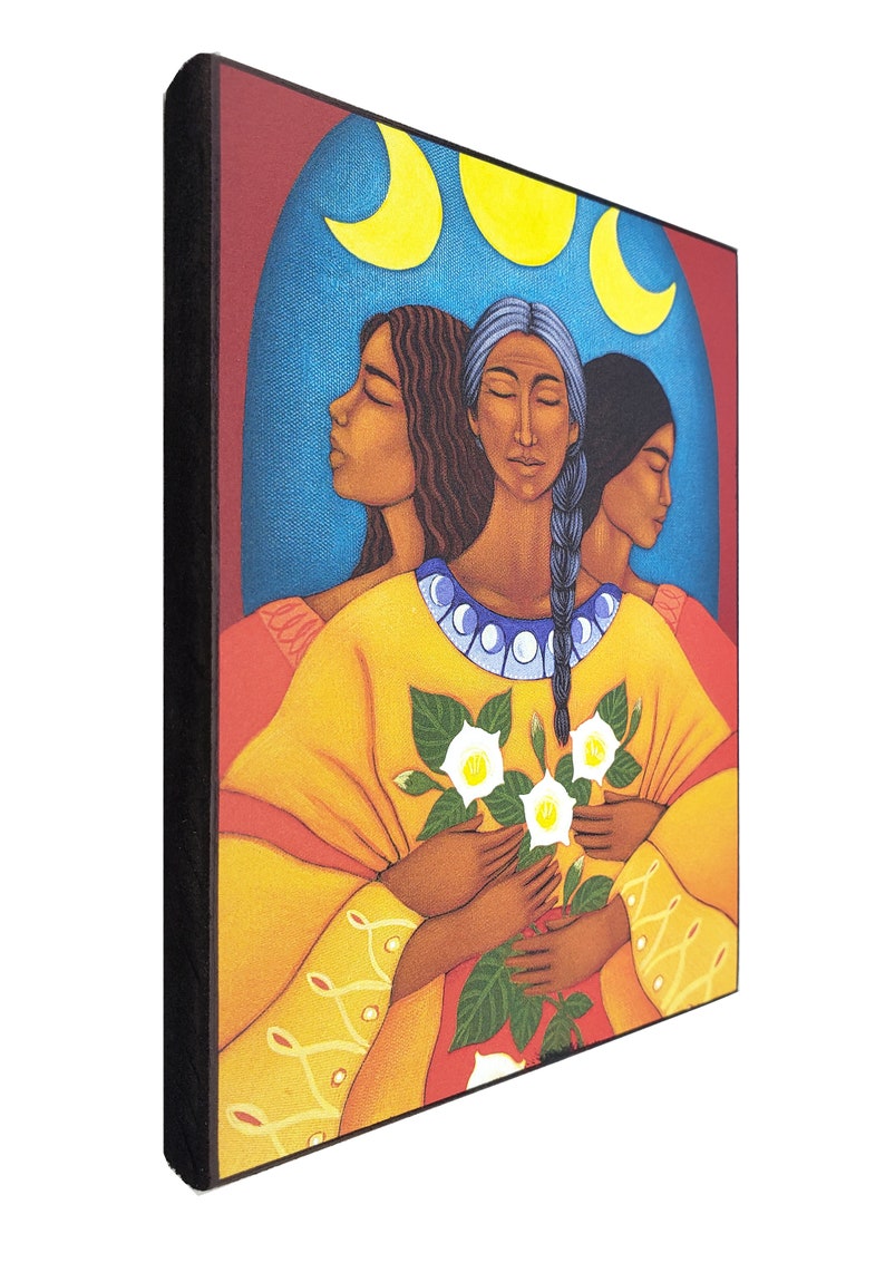 May include: Three women with dark hair and brown skin are depicted in a painting. They are wearing yellow robes and holding white flowers. The background is a blue sky with three yellow crescent moons.