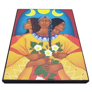May include: A painting of three women with dark hair and brown skin, standing together and holding a bouquet of white flowers. The women are wearing yellow and red clothing, and the background is a blue and red arch with three crescent moons.