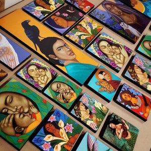 May include: A collection of small, framed paintings featuring colorful, stylized portraits of women and children. The paintings are set against a variety of backgrounds, including floral patterns, geometric shapes, and abstract designs.