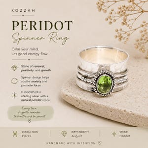 May include: A sterling silver spinner ring featuring a central oval-cut green peridot stone set within a twisted rope border. The band has a hammered texture and includes additional silver bands that rotate around the main ring structure.