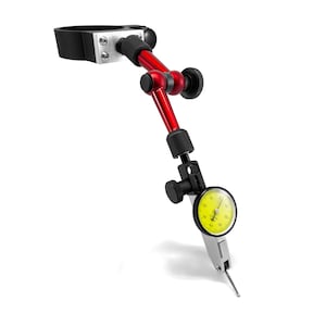 May include: A red magnetic base dial indicator with a yellow dial and a black clamp. The dial indicator is attached to a red arm with a black knob. The arm is attached to a black magnetic base.