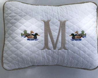 Quilted pillow cover with monogram and design