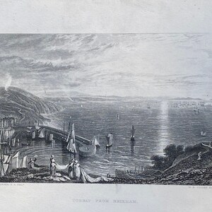 May include: A black and white engraving of a coastal scene with a town in the distance and a harbor with boats. The title of the engraving is "View from Brehan."