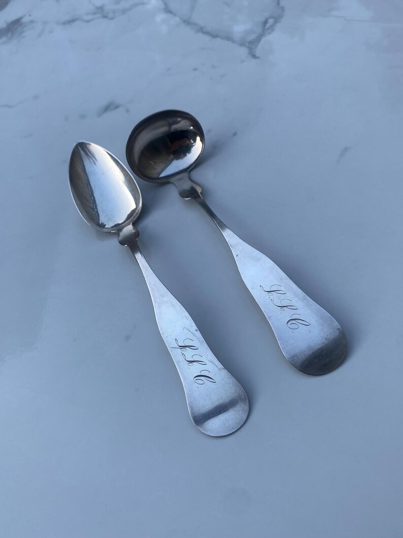May include: Two antique silver spoons with engraved initials "J.S.G" and "J.H.D".