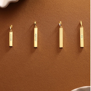 May include: Four gold-colored pendant necklaces. Two pendants have names engraved: "Meggy" and "Scarlett". The other two pendants have a ribbed design and initials "R&P". All pendants have a small loop at the top for a chain.