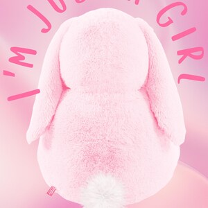 Könnte beinhalten: Rosa Plüsch-Hasenfigur mit einem weißen, flauschigen Schwanz. Der Hase sitzt auf einem rosa Hintergrund mit dem Text "I'm just a girl" drumherum.