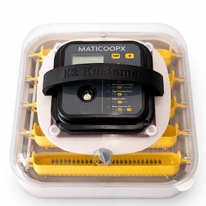 May include: A clear and white incubator with yellow components. The incubator has a digital display with the text "MATICCOOPX" and "K2 Kustoms". A black strap secures the digital display. The incubator is designed for hatching eggs.
