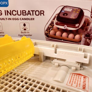 May include: A set of three ceramic mugs with a speckled, matte finish. The mugs are in shades of cream, light gray, and dark gray. Each mug has a simple, minimalist design and a rounded handle. The mugs are likely for coffee or tea.