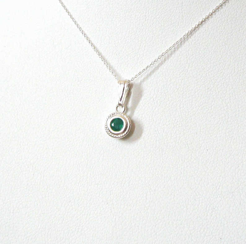 A faceted Green Onyx 4mm gemstone is set into a sterling silver solitaire pendant setting. The lovely emerald green color makes it a pretty substitute for emerald, the birthstone for May birthdays. Comes with a 16 or 18 inch 925 sterling chain.