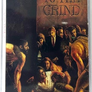 May include: A cassette tape with the album art for Skid Row's "Slave to the Grind." The cover features a dark, dramatic illustration with the album title in large, embossed letters. The artwork depicts a crowd of people in a distressed scene.