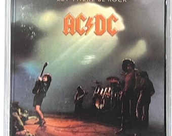 May include: A vintage cassette tape of the AC/DC album "Let There Be Rock." The cover features the band performing live, with the album title and band name prominently displayed in bold text. The ATCO logo is visible.