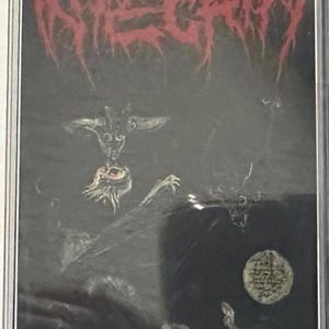 May include: A cassette tape with a black background and the word "INTEGRITY" in red, stylized lettering. The cover art features a demonic figure and other dark imagery, suggesting a heavy metal or extreme music genre.