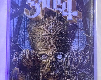 May include: A cassette tape with a dark, gothic-style album cover. The cover features the band name "Ghost" in a stylized font above a detailed illustration of a skeletal figure with ornate architectural elements and a cross.