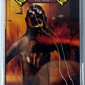 May include: A Machine Head "Burn My Eyes" cassette tape. The cover art features a dark, blurred figure with white lines and the band's logo in yellow and black. The background is a mix of orange and red.