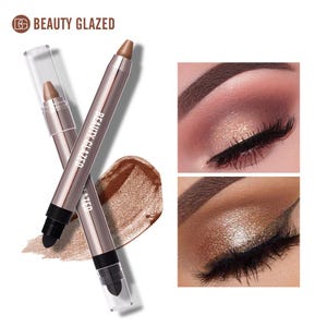 May include: Two Beauty Glazed eyeshadow sticks with metallic brown pigment, clear caps, and integrated sponge applicators. A swatch of shimmering bronze cream eyeshadow is visible, alongside two panels showing the product applied to eyelids.