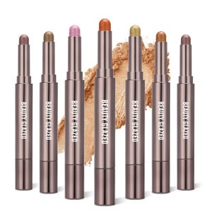 May include: Seven metallic eyeshadow sticks in various colors, including bronze, gold, and pink. Each stick has a silver tube with the words "BEAUTY GLAZED" printed on it. The eyeshadow sticks are arranged in a row against a white background.