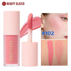 May include: A pink liquid blush from Beauty Glazed. The product is in a clear bottle with a pink cap and the brand name printed on the front. The image also shows a swatch of the blush and a close-up of a face with the blush applied.