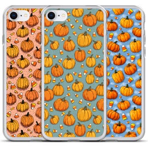 May include: Three phone cases with pumpkin and candy corn patterns. The cases feature orange pumpkins and candy corn on a peach, teal, and blue background. The cases are designed for a smartphone.