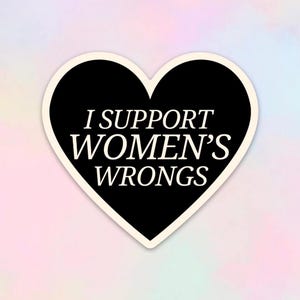 May include: Black heart-shaped sticker with the text "I support women's wrongs" in white.