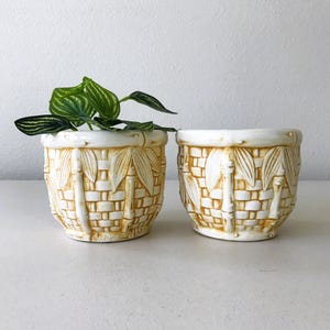 May include: A set of three ceramic mugs with a speckled, matte finish. The mugs are in shades of cream, light gray, and dark gray. Each mug has a simple, minimalist design, perfect for coffee or tea.