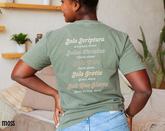 May include: A green t-shirt with the text "Sola Scriptura, scripture alone", "Solus Christus, Christ alone", "Sola Fide, faith alone", "Sola Gratia, grace alone", and "Soli Deo Gloria, glory to God alone" printed on the back.