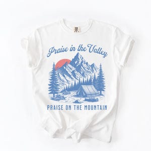 Elevation Brandon Lake Fan Shirt Praise in the Valley Praise on the Mountain Comfort Colors 1717 tee,tshirt in neutral colors trendy with praise in the valley in cursive font and praise on the mountain in a sans serif witha blue print of a mountain