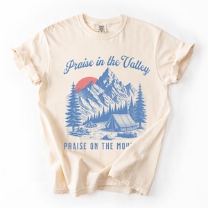 Elevation Brandon Lake Fan Shirt Praise in the Valley Praise on the Mountain Comfort Colors 1717 tee,tshirt in neutral colors trendy with praise in the valley in cursive font and praise on the mountain in a sans serif witha blue print of a mountain