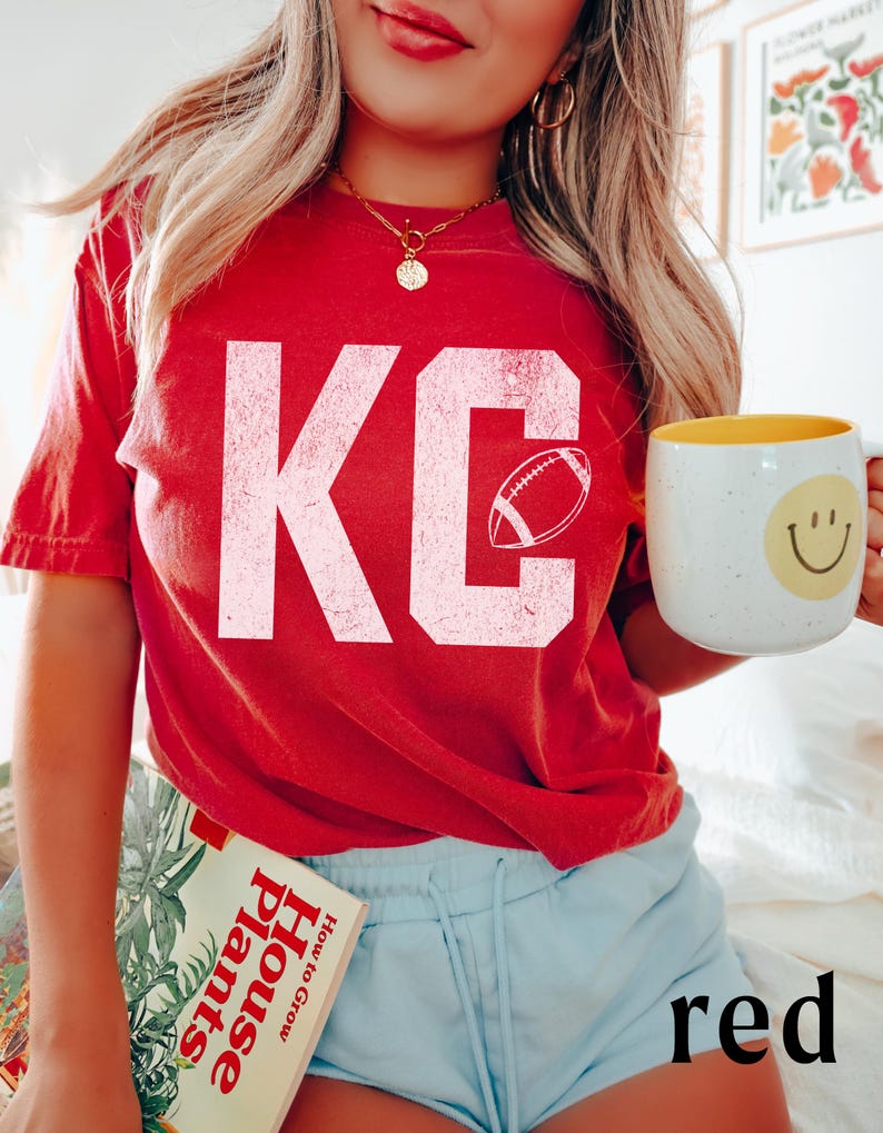 A simple textured looking KC printed on a soft and durable comfort colors 1717 tshirt- with an outline of a football in the letter C- perfect for game day or any Red Friday in Kansas City to celebrate the Chiefs