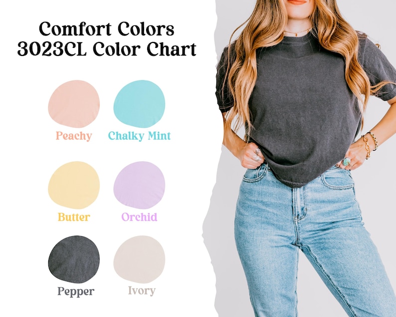 May include: A woman in a dark grey t-shirt and light blue jeans. The image features a colour chart with the text "Comfort Colors 3023CL Color Chart" and colour swatches labelled Peachy, Chalky Mint, Butter, Orchid, Pepper, and Ivory.