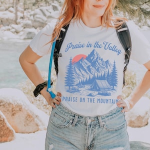 Elevation Brandon Lake Fan Shirt Praise in the Valley Praise on the Mountain Comfort Colors 1717 tee,tshirt in neutral colors trendy with praise in the valley in cursive font and praise on the mountain in a sans serif witha blue print of a mountain