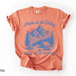 Elevation Brandon Lake Fan Shirt Praise in the Valley Praise on the Mountain Comfort Colors 1717 tee,tshirt in neutral colors trendy with praise in the valley in cursive font and praise on the mountain in a sans serif witha blue print of a mountain