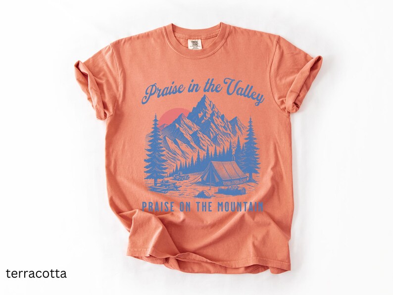 Elevation Brandon Lake Fan Shirt Praise in the Valley Praise on the Mountain Comfort Colors 1717 tee,tshirt in neutral colors trendy with praise in the valley in cursive font and praise on the mountain in a sans serif witha blue print of a mountain