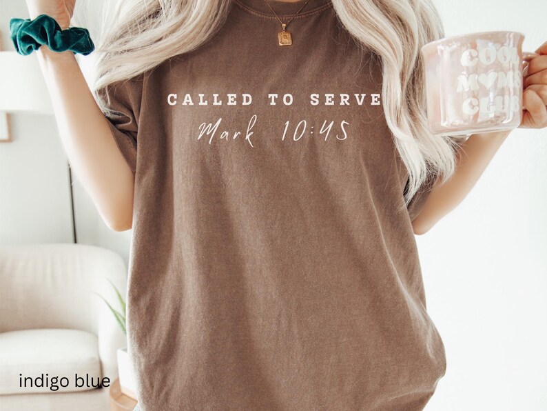 May include: A brown t-shirt with the text "Called to Serve Mark 10:45" printed in white.