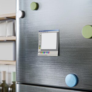 May include: A square refrigerator magnet featuring a graphic print of a classic computer paint program interface. The design includes a white canvas area, a vertical toolbar with various drawing icons, a color palette at the bottom, and a blue title bar.
