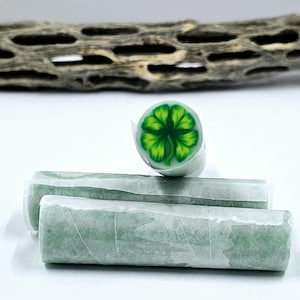 May include: Three green polymer clay sticks, one with a four-leaf clover design.