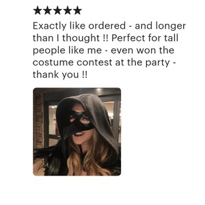 May include: A woman wearing a black hooded cloak and a black mask. The text in the image reads: "Exactly like ordered - and longer than I thought !! Perfect for tall people like me - even won the costume contest at the party - thank you !!"