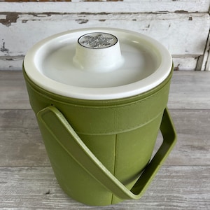 May include: A green plastic ice bucket with a white lid and a handle. The lid has a snowflake design.