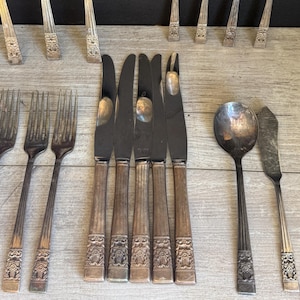 May include: A set of three ceramic mugs with a speckled, matte finish. The mugs are in shades of cream, light gray, and dark gray. Each mug has a simple, minimalist design, perfect for coffee or tea.