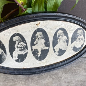 May include: An oval-shaped black framed picture with a white background featuring five black and white photos of young girls in various poses. The photos are arranged in a row and each has a title below it. The title below the first photo is "Smiling", the second is "Holding", the third is "The Five Bunnies", the fourth is "Tattling", and the fifth is "Crying".