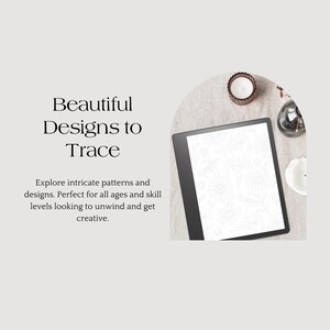 May include: A black and white digital drawing tablet with a screen displaying intricate patterns for tracing. The tablet is on a beige surface with candles and other decorative items.