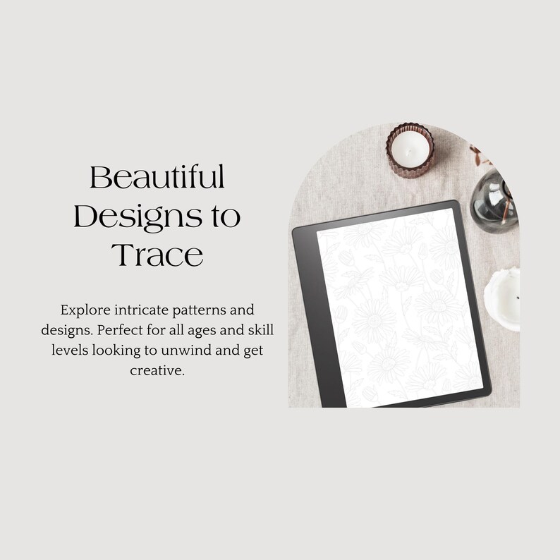 May include: A black and white digital drawing tablet with a screen displaying intricate patterns for tracing. The tablet is on a beige surface with candles and other decorative items.