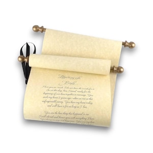 May include: A rolled parchment scroll with gold-colored finials and a black ribbon. The scroll features handwritten text, including the words "Letter to my wife Emily" and a personal message. The paper has a vintage, aged appearance.