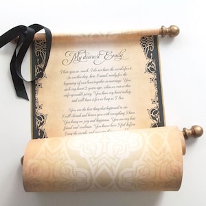 May include: A vintage-style scroll with a handwritten message, featuring decorative borders and gold-colored finials. The scroll is tied with a black ribbon. The text reads "My dearest Emily" and a heartfelt message.