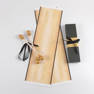 vintage style scroll kit with unassembled paper, gold finials, and black ribbon. includes a black gift box with paper band and ribbon.