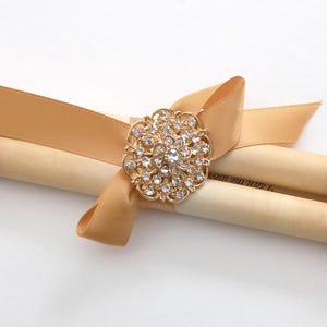 Green and gold paper scroll with brooch