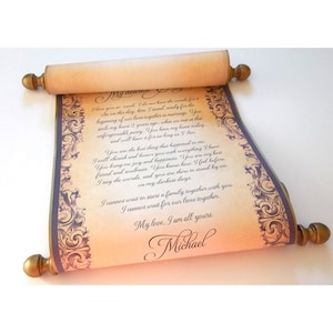 May include: A rolled parchment scroll with a handwritten message, featuring ornate purple and gold border designs. The scroll is held by wooden dowels with gold finials. The text reads "My dearest... I love you so much... My love, I am all yours, Michael."