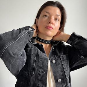 Black leather choker necklace with metal accents, adjustable gothic punk accessory
