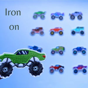May include: Green monster truck iron-on patch. The patch is in the shape of a monster truck with large wheels and a green body. The words "Iron on" are written in white text above the patch.