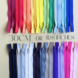May include: Assortment of 30cm or 11.81 inch zipper closures in various colours, including red, orange, yellow, green, blue, purple, and black.